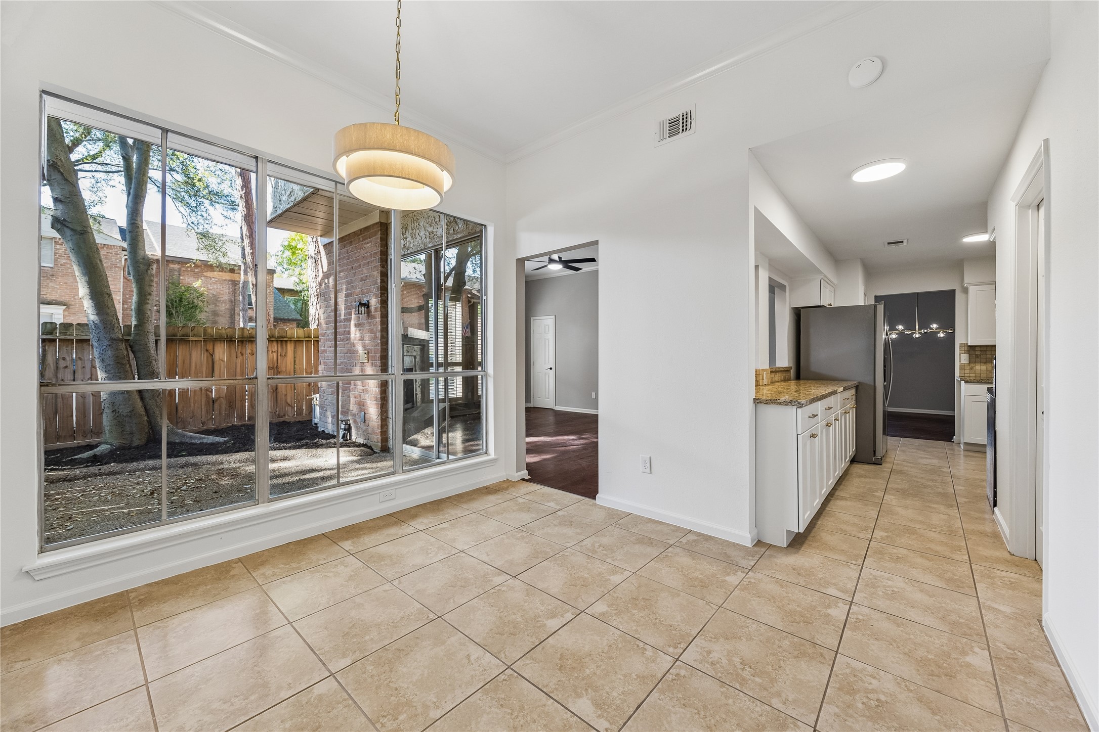 15066 Kimberley Court Houston, TX 77079 - Photo 10 of 27 A breakfast area with large windows overlooking the private, fenced patio. Enjoy natural light and a peaceful view while dining or sipping your morning coffee.