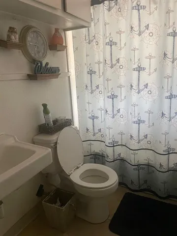 a bathroom with a toilet a sink and a shower