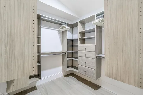 a view of walk in closet with empty racks