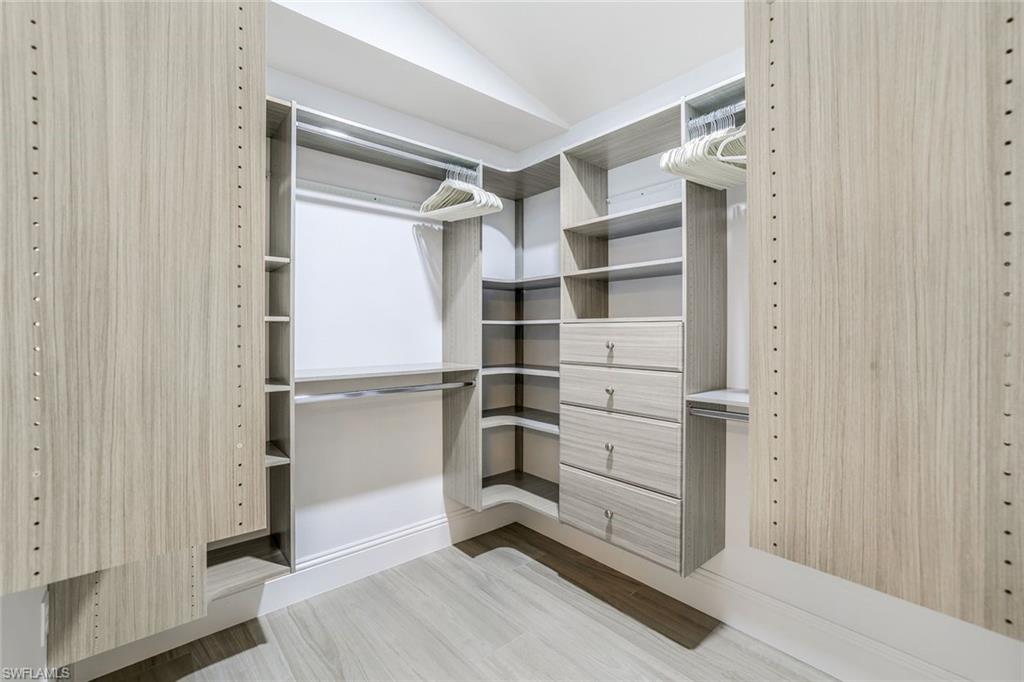 914 Marble Drive Naples, FL 34104 - Photo 17 of 50 a view of walk in closet with empty racks