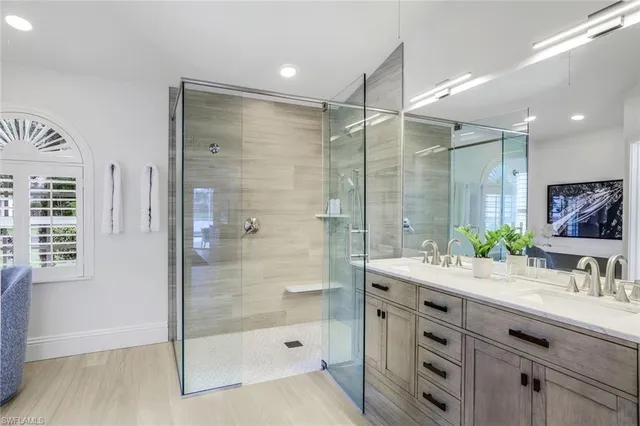 a bathroom with a shower sink and mirror