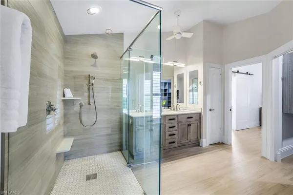 a bathroom with a double vanity sink mirror double and shower