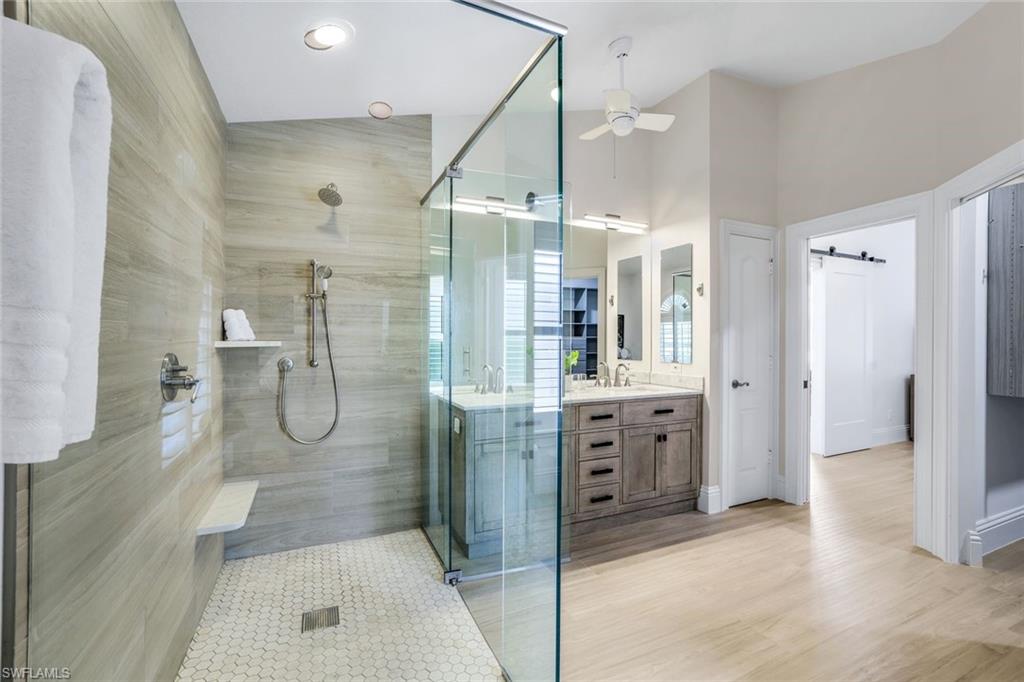 914 Marble Drive Naples, FL 34104 - Photo 21 of 50 a bathroom with a double vanity sink mirror double and shower