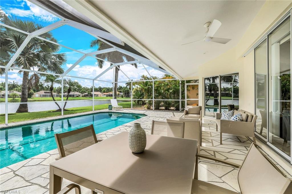 914 Marble Drive Naples, FL 34104 - Photo 27 of 50 a view of a patio with table and chairs potted plants with floor to ceiling window