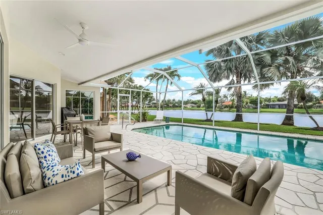 a view of a patio with couches and pool