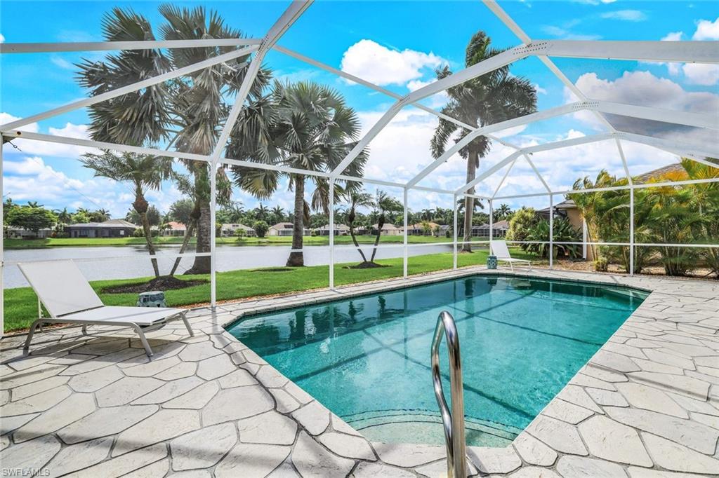 914 Marble Drive Naples, FL 34104 - Photo 30 of 50 a view of a swimming pool with a lounge chairs