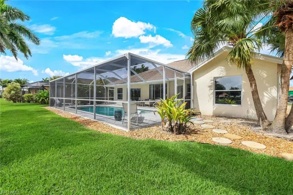 a view of a house with a backyard porch and sitting area