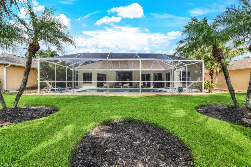 914 Marble Drive Naples, FL 34104 - Photo 36 of 50 a front view of a house with a yard table and chairs