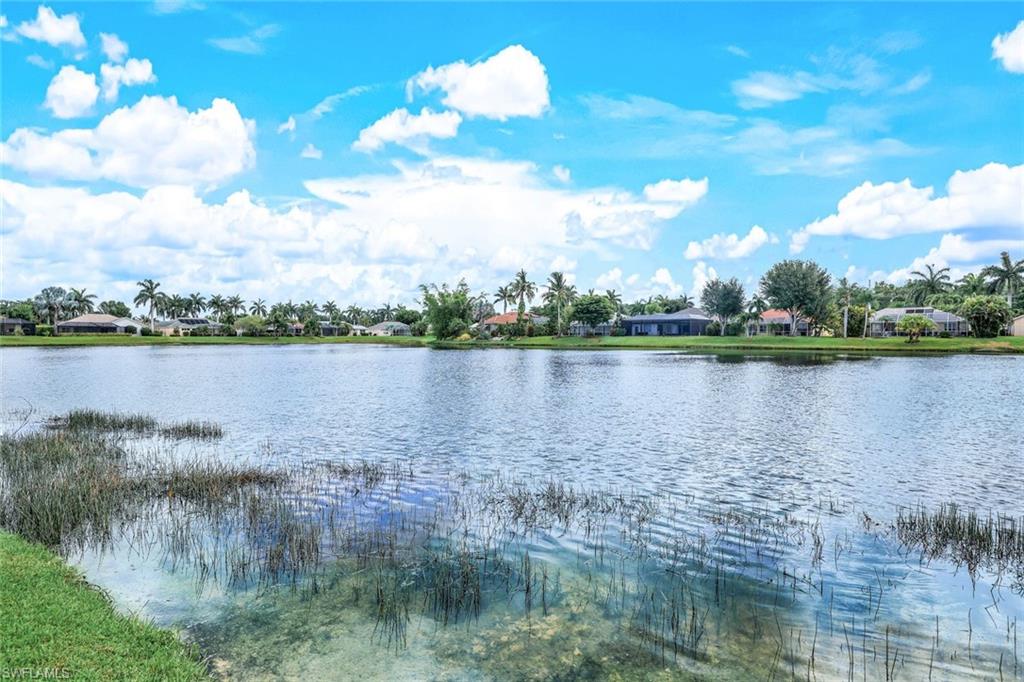 914 Marble Drive Naples, FL 34104 - Photo 37 of 50 a view of a lake with a city