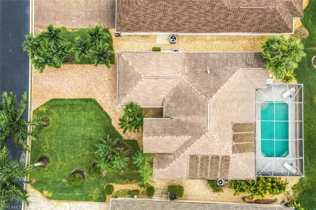 an aerial view of a residential houses with outdoor space