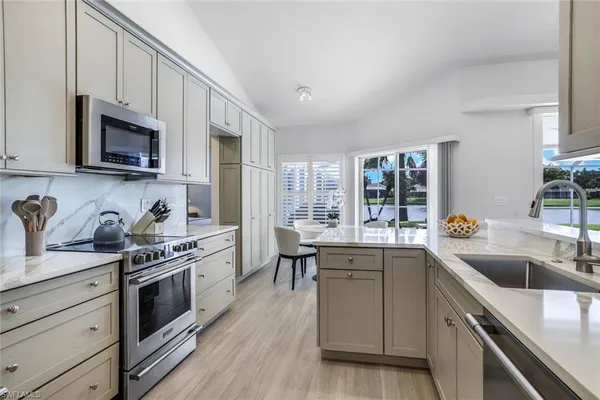 a kitchen with stainless steel appliances granite countertop a sink and stove top oven