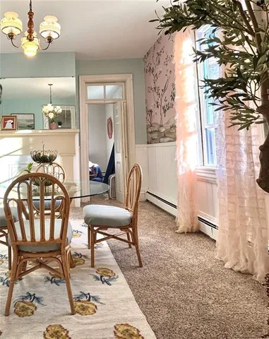 a view of a dining room with furniture and a chandelier
