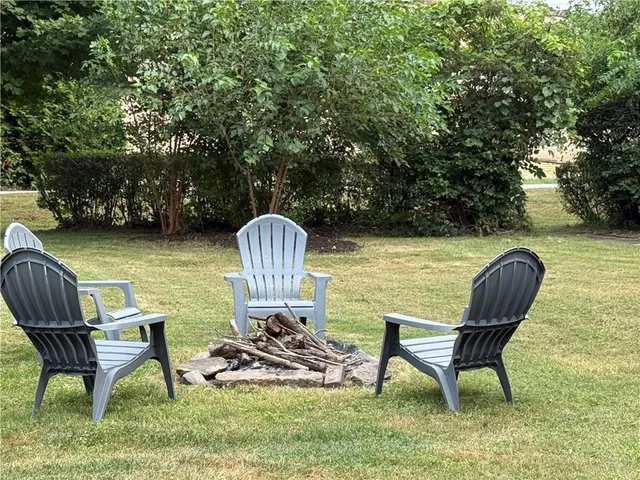 a view of a chairs and table in patio