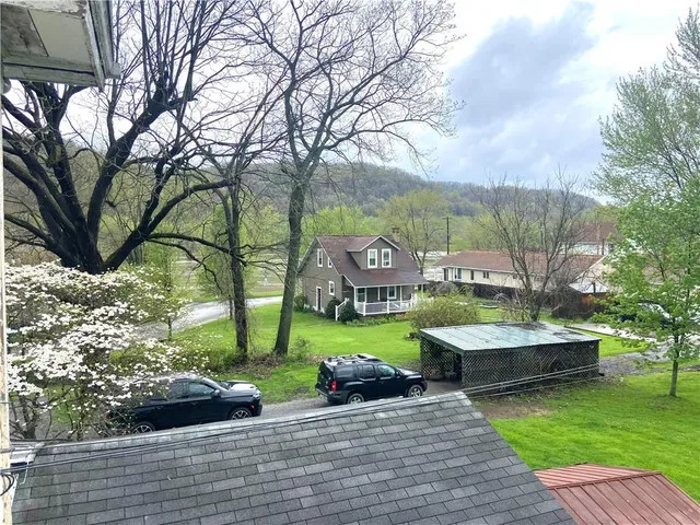 a view of yard with green space and seating area