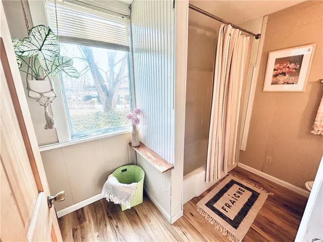 a view of a bedroom with a bed and a window