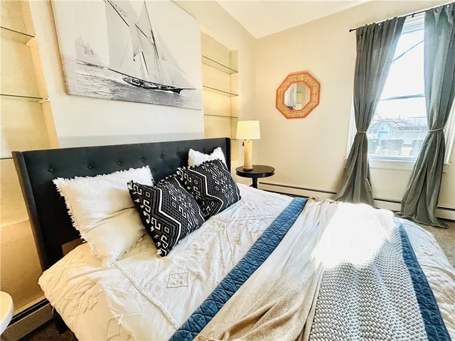 a bed sitting in a bedroom next to a window