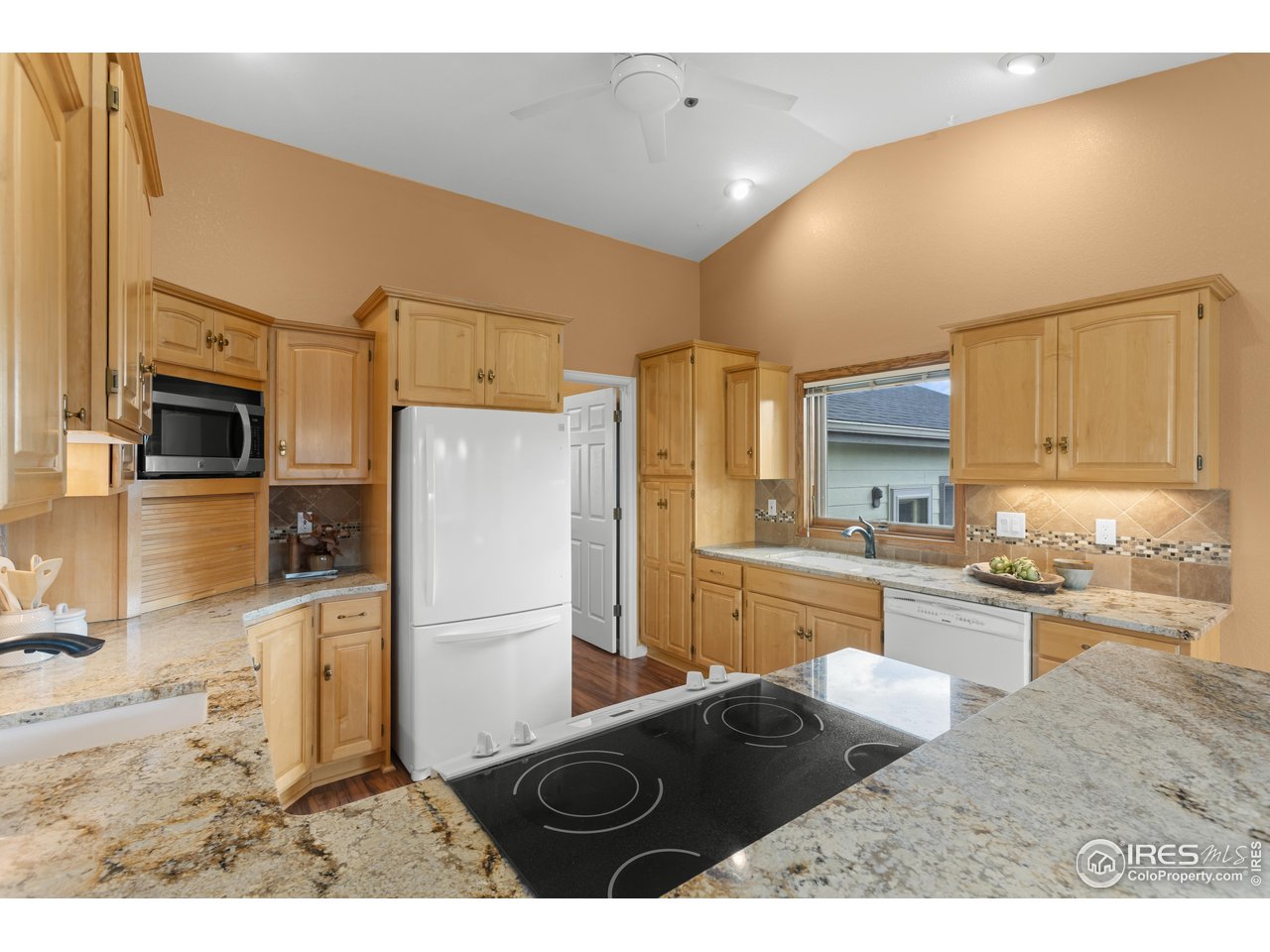 3308 Innisfree Lane Laporte, CO 80535 - Photo 19 of 50 a kitchen with granite countertop a refrigerator stove top oven and sink