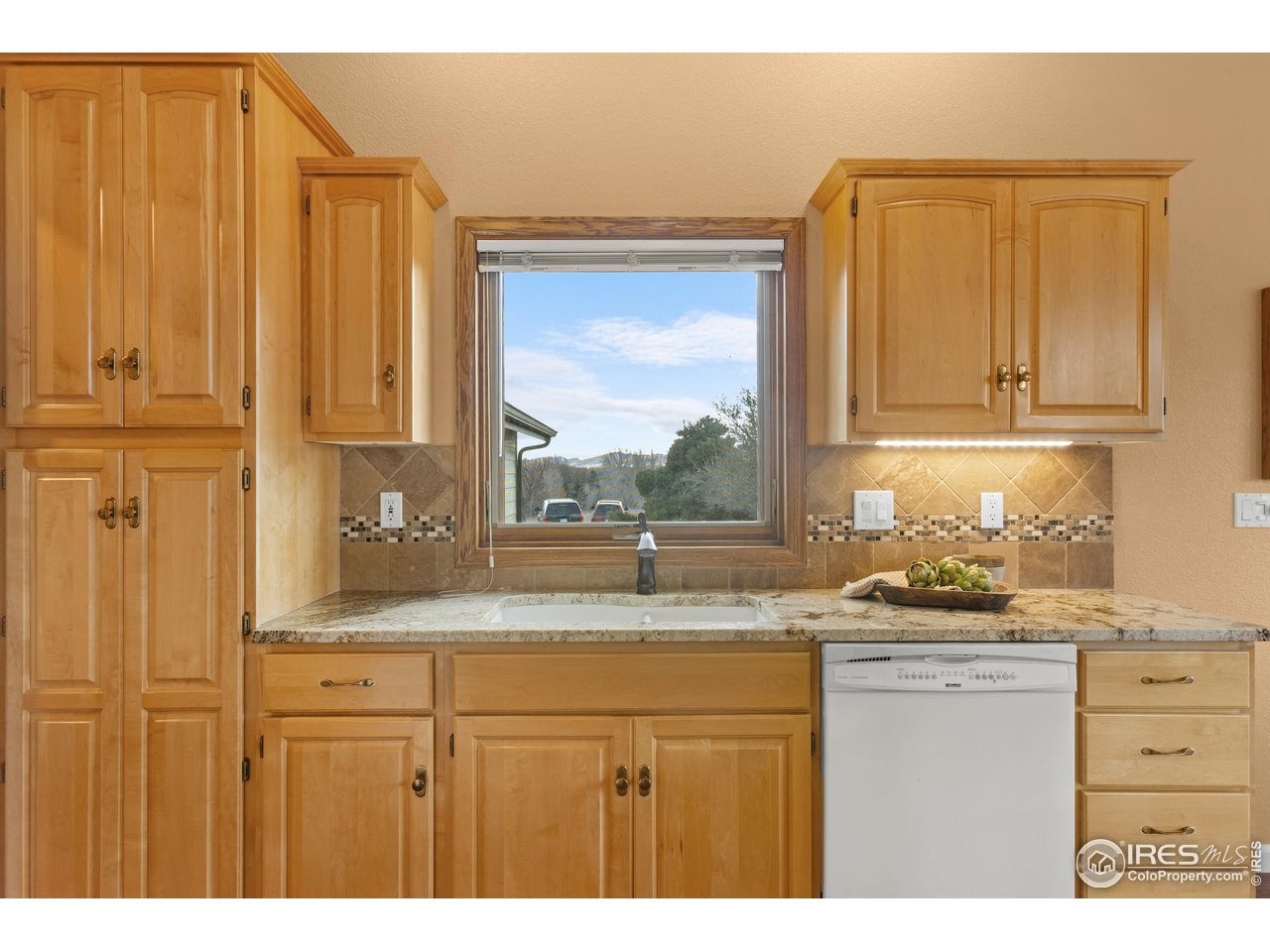 3308 Innisfree Lane Laporte, CO 80535 - Photo 20 of 50 a kitchen with granite countertop a sink window and cabinets