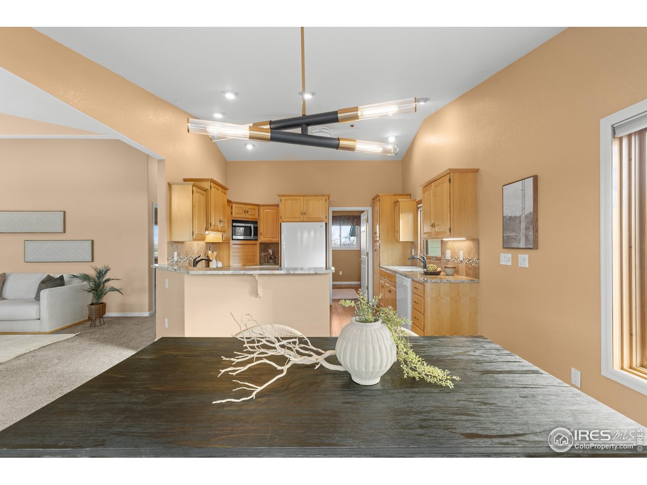 3308 Innisfree Lane Laporte, CO 80535 - Photo 22 of 50 a living room with kitchen island furniture and a chandelier