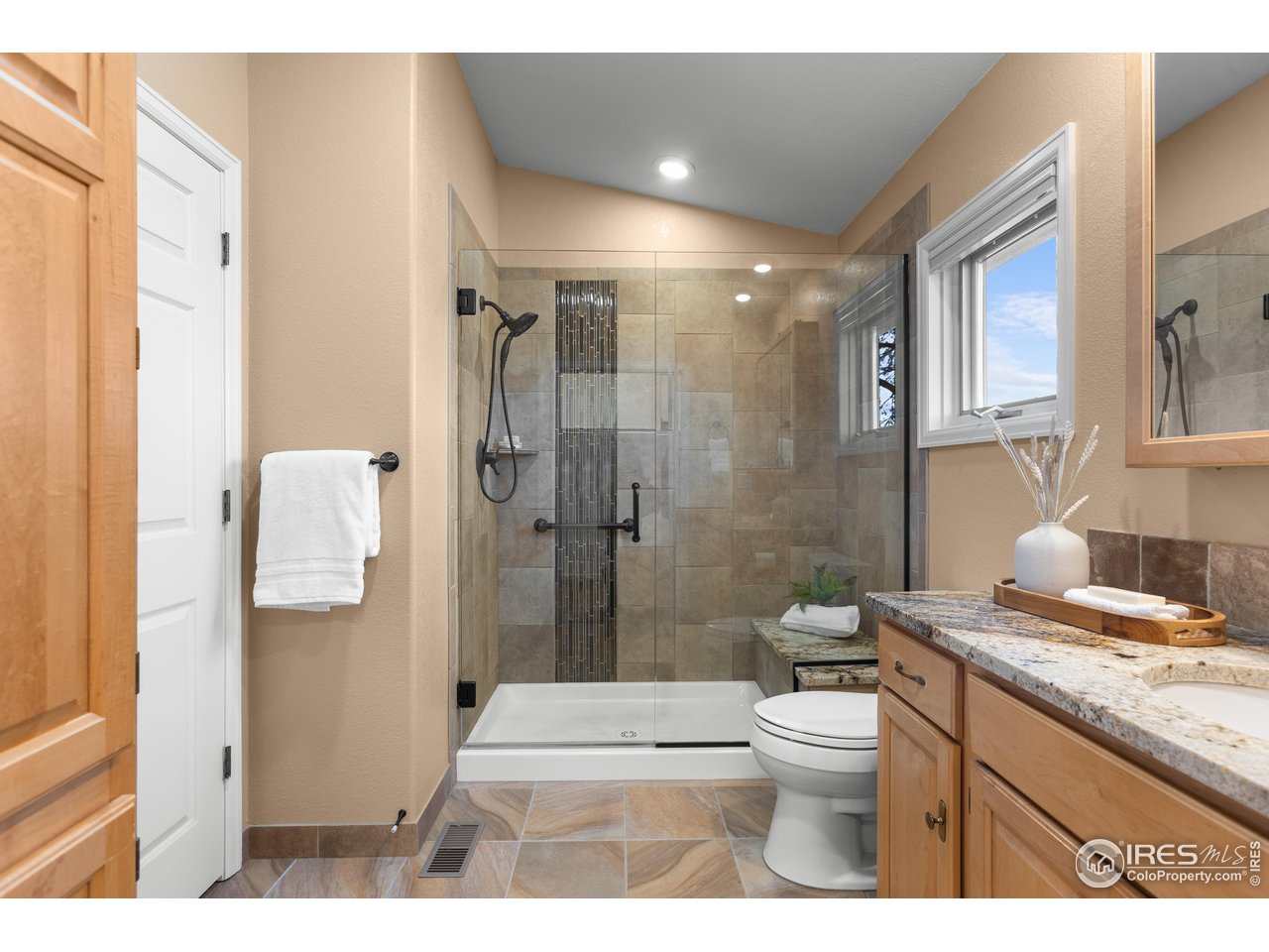 3308 Innisfree Lane Laporte, CO 80535 - Photo 37 of 50 a bathroom with a granite countertop sink a toilet a shower and a mirror