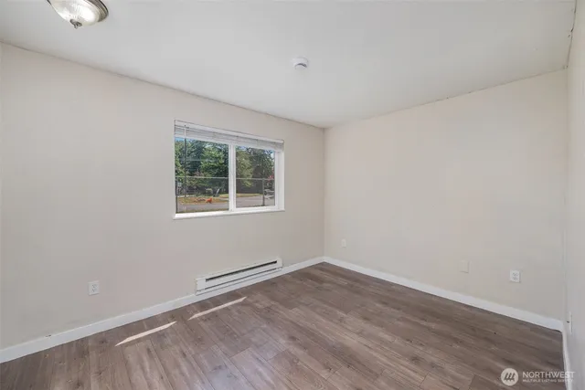 wooden floor in an empty room with a window