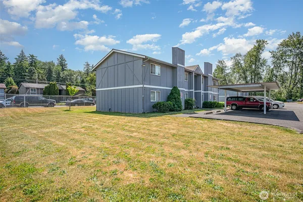 a swimming pool with outdoor seating and yard