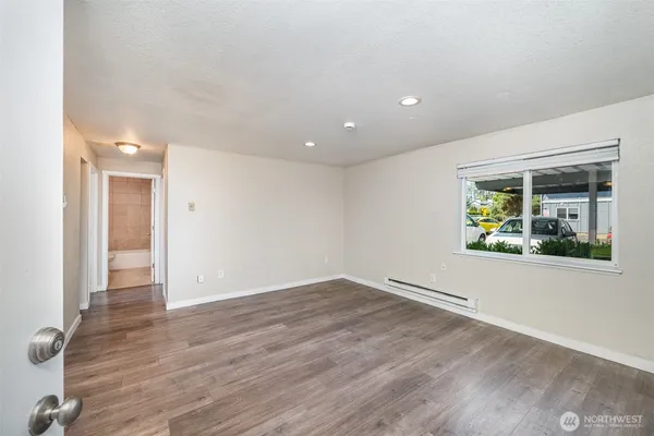 wooden floor in an empty room with a window