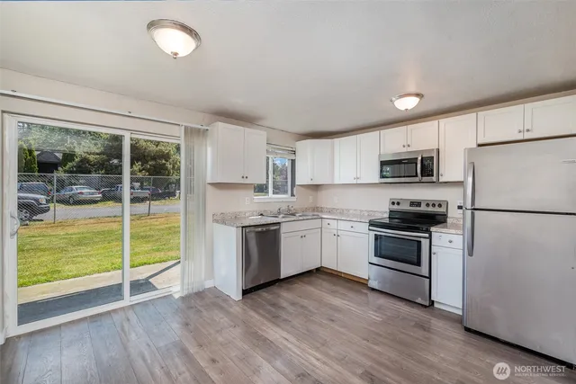 a kitchen with a refrigerator stove top oven and sink
