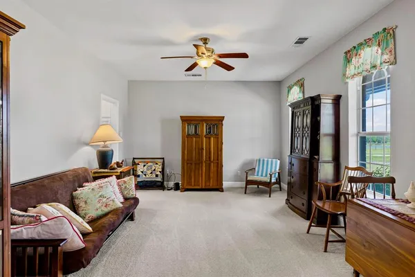 a bedroom with furniture and a window