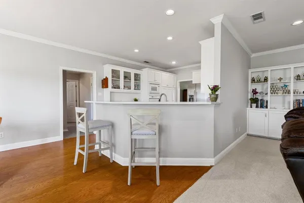 a living room with stainless steel appliances kitchen island granite countertop furniture and a kitchen view