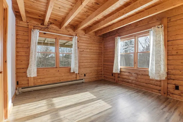 a view of wooden floor and windows in an empty room