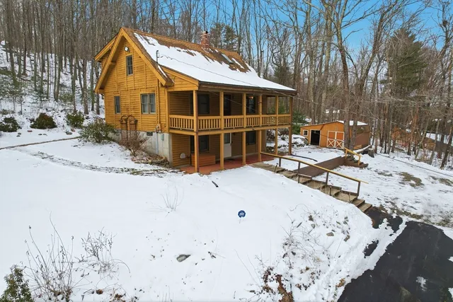 a view of a house with a snow on the road