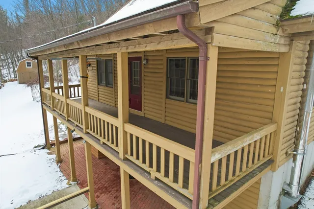 a view of a house with wooden fence