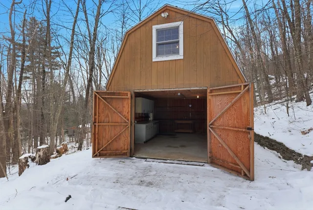 a view of a house with a snow in the yard