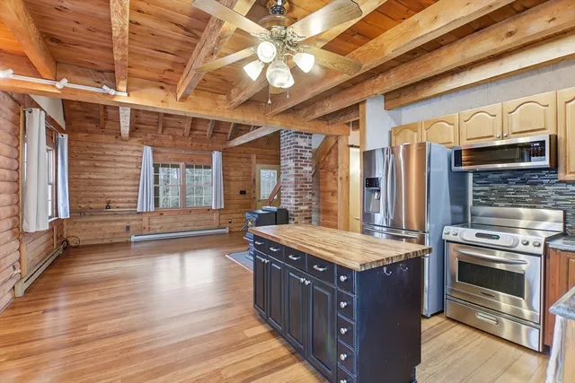 a kitchen with wooden cabinets and a stove