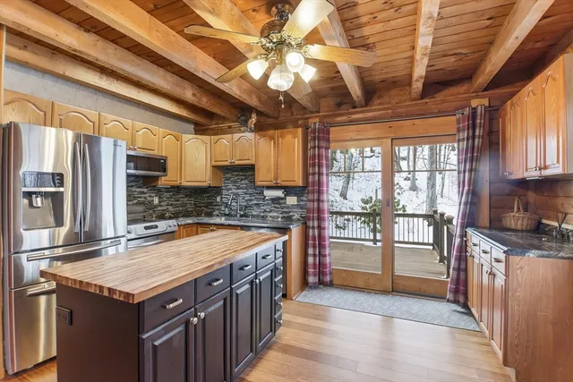 a kitchen that has a lot of cabinets in it and stainless steel appliances