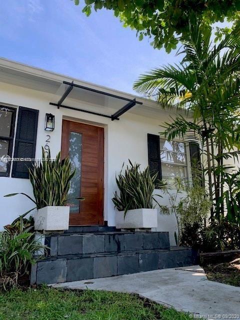 260 Northeast 48th Terrace Miami, FL 33137 - Photo 1 of 14 a front view of a house with a yard