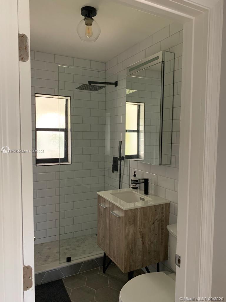 260 Northeast 48th Terrace Miami, FL 33137 - Photo 11 of 14 a bathroom with a sink a toilet and shower