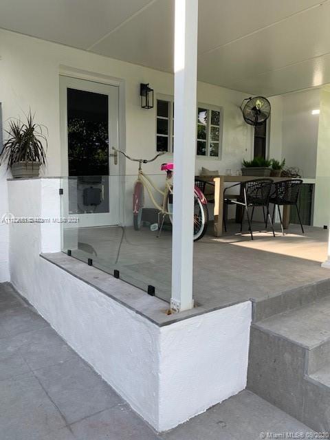 260 Northeast 48th Terrace Miami, FL 33137 - Photo 3 of 14 a living room with furniture and a flat screen tv