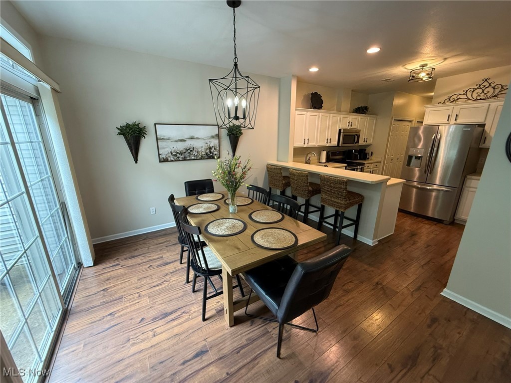 5645 Clingan Road, Unit 2D Struthers, OH 44471 - Photo 10 of 50 Dining space with recessed lighting, baseboards, dark wood-style flooring, and a chandelier