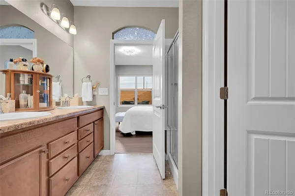 a spacious en suite bathroom with a sink and mirror