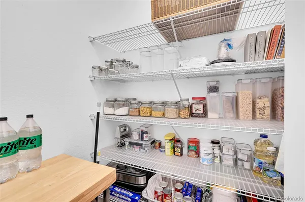a living room with lots of clutter and cabinets