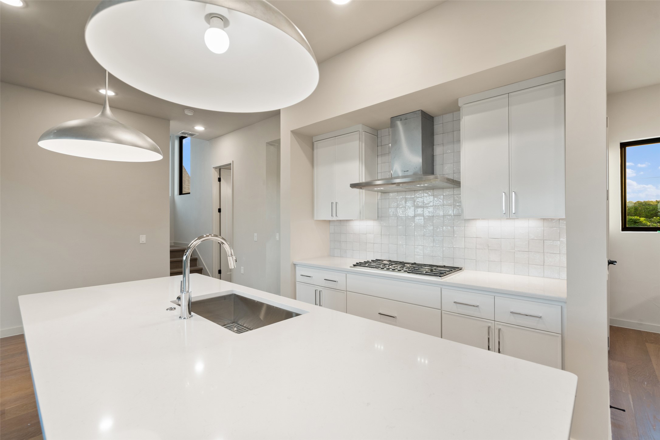9803 Ribelin Ranch Court, Unit 16 Austin, TX 78750 - Photo 8 of 31 Sleek modern cabinetry and a large central island anchor this open culinary space.