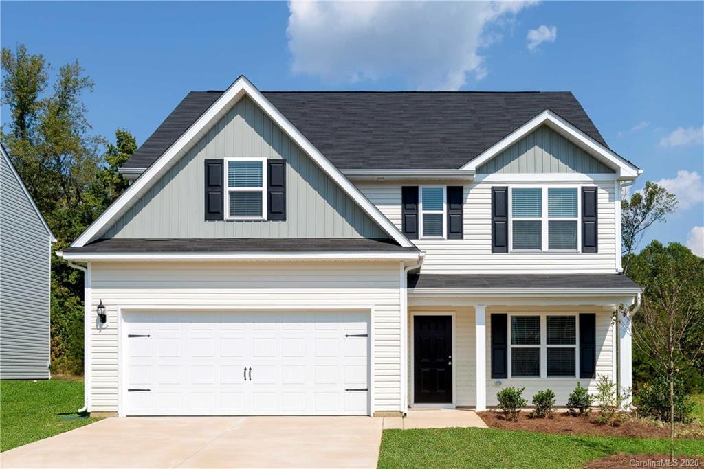 1215 Culver Spring Way Charlotte, NC 28215 - Photo 1 of 13 a front view of a house with garden