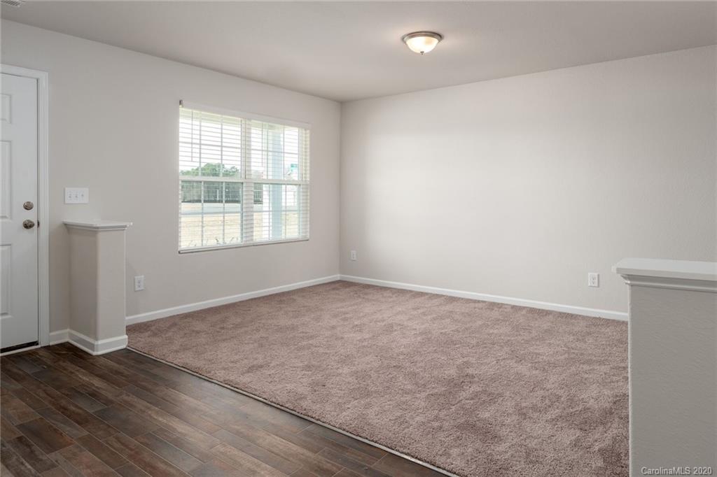 1215 Culver Spring Way Charlotte, NC 28215 - Photo 4 of 13 an empty room with wooden floor and windows