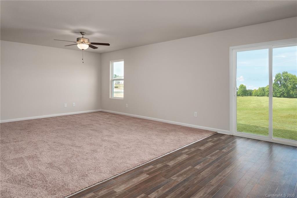 1215 Culver Spring Way Charlotte, NC 28215 - Photo 7 of 13 a view of an empty room with wooden floor and a window