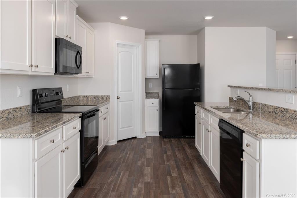 1215 Culver Spring Way Charlotte, NC 28215 - Photo 8 of 13 a kitchen with stainless steel appliances granite countertop a refrigerator stove and sink