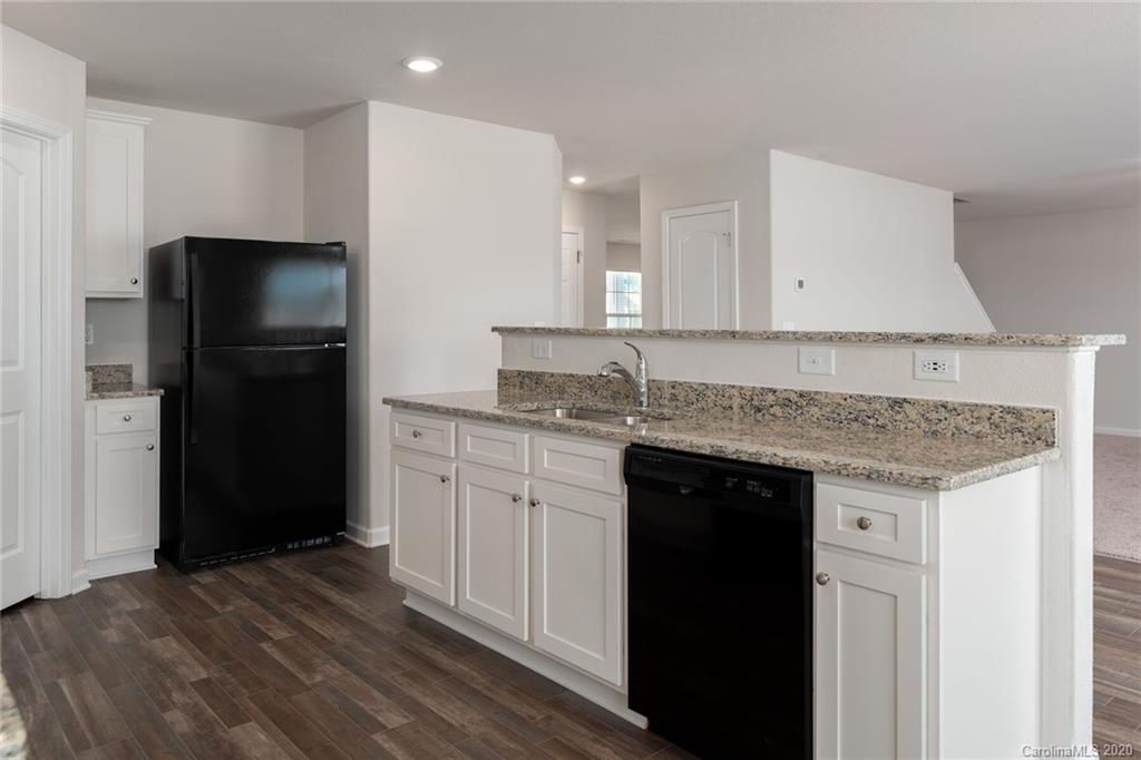 1215 Culver Spring Way Charlotte, NC 28215 - Photo 10 of 13 a kitchen with a refrigerator and a sink