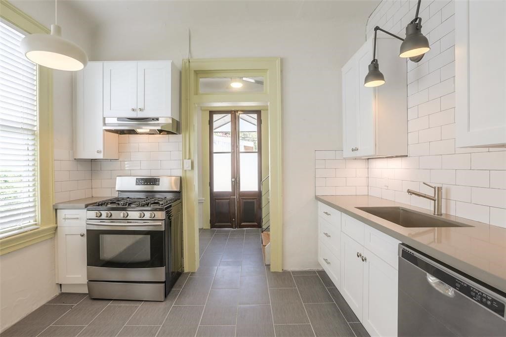 1013 East 26th Street Houston, TX 77009 - Photo 4 of 10 a kitchen with a stove sink and cabinets