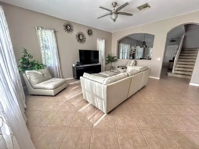 a living room with furniture and a flat screen tv